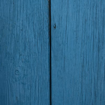 Closeup of wooden door painted in dark blue