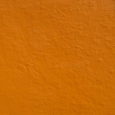 Bright Orange painted wall showing a lot of relief