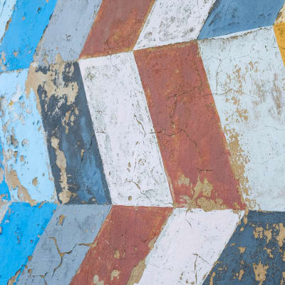 Weathered colorful red blue white wall design from cuba