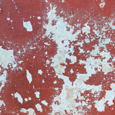 Red rusted background of a weathered wall